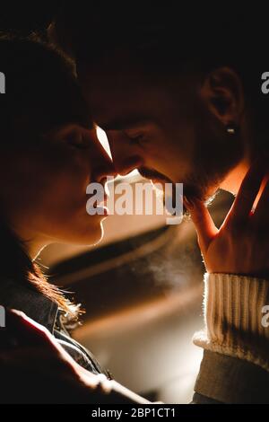 Man and woman touching each other with their noses before kissing Stock Photo