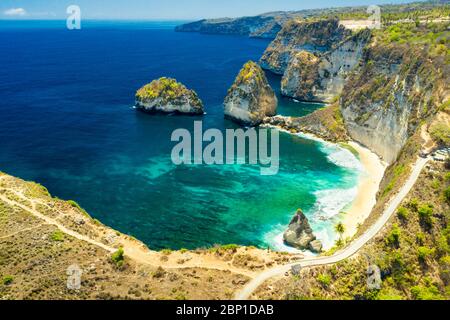 Aerial view at nature landscape with sand beach sea and rocks. Amazing mountain cliff in the azure ocean water. Stock Photo