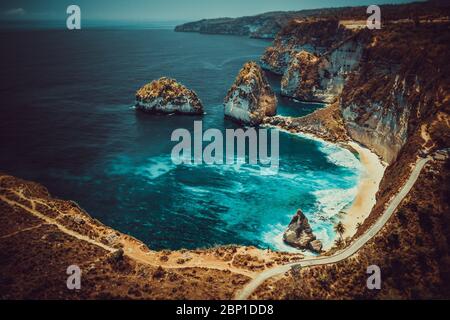 Aerial view at nature landscape with sand beach sea and rocks. Amazing mountain cliff in the azure ocean water. Stock Photo