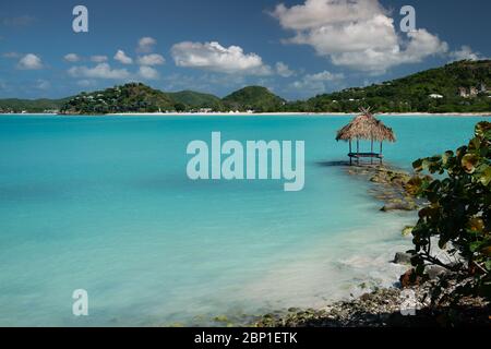 Tropical Paradise Straw Water Hut Lounger in Antigua, Caribbean Stock Photo