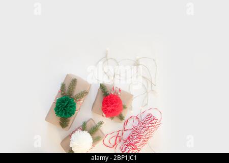 top view of arranged wrapped christmas gift boxes with ribbons on white tabletop Stock Photo