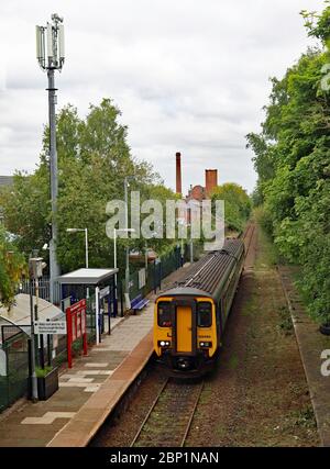 A train passes through Burscough Junction station with a route refresher train in readiness for restarting passenger services along this branch line. Stock Photo