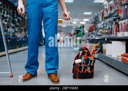 Toolbox in tool store, worker on background Stock Photo