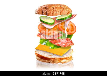 Flying tasty sandwich. Sandwich with flying ingredients isolated on white background. Stock Photo