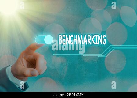 Conceptual hand writing showing Benchmarking. Concept meaning evaluate something by comparison with standard or scores Stock Photo