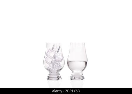 Ice melting concept with one whisky glass full of ice and a second image of another whisky glass half full of water showing the melted ice Stock Photo