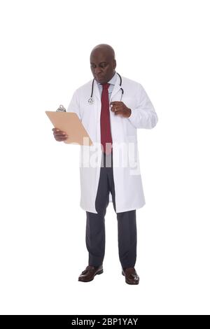 African American doctor with stethoscope reading notes on a clipboard with a serious expression Stock Photo
