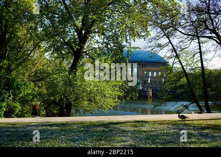 Romantic Spring scenery in the public park 'Ständehauspark' with an ancient building ('Ständehaus') in the background that was built from 1876 - 1880. Stock Photo