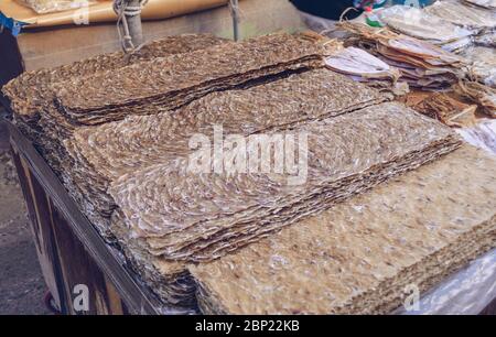 variety of dried sea food: octopuses, squids, thin pieces of dried fish for sale at korean market Stock Photo