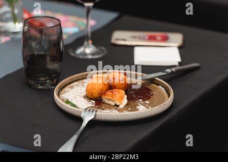 handmade cottage cheese balls, hungarian sweet dessert served with sweat strawberry jam Stock Photo