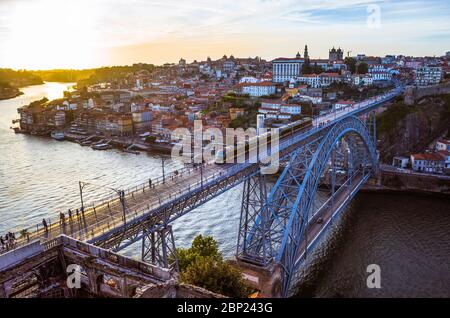Porto, Portugal : A train rides at sunset on the Dom Luis I Bridge over the River Douro linking Porto and Vila Nova de Gaia, built betwen 1881 and 188 Stock Photo