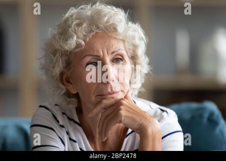 Unhappy middle aged grandmother suffering from depression. Stock Photo