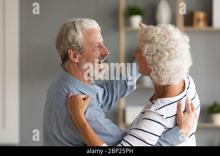 Happy loving married middle aged couple dancing in pair. Stock Photo