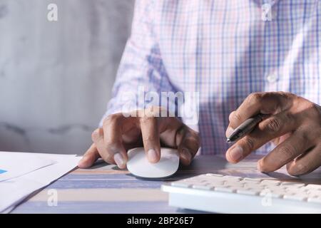 Businessman hand with computer mouse, Close up Stock Photo