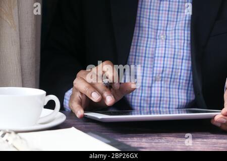 Businessman in suit working on digital tablet  Stock Photo