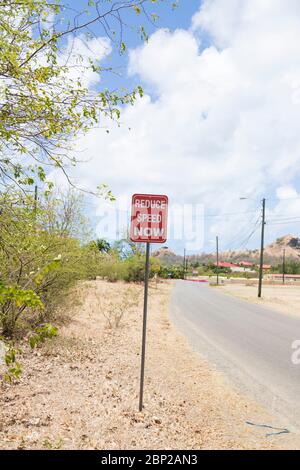Reduce speed now road sign Stock Photo