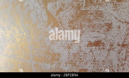Grungy wall texture with golden marble pattern on grey structure. Abstract interior background with copy space Stock Photo