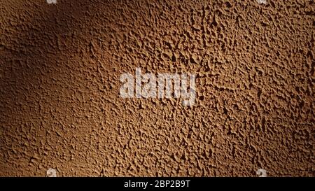 Rough plaster stucco wall texture closeup. Abstract textured brown background with copy space Stock Photo