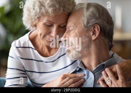 Peaceful senior older family couple soulmates showing love and care. Stock Photo