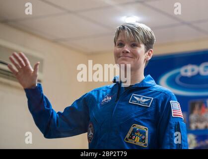 Expedition 58 Press Conference  Expedition 58 Flight Engineer Anne McClain of NASA waves during a press conference, Sunday, Dec. 2, 2018 at the Cosmonaut Hotel in Baikonur, Kazakhstan. Launch of the Soyuz rocket is scheduled for Dec. 3 and will carry McClain, Soyuz Commander Oleg Kononenko of Roscosmos, and David Saint-Jacques of the Canadian Space Agency (CSA) into orbit to begin their six and a half month mission on the International Space Station. Stock Photo