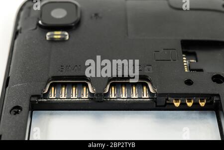 Slot for dual SIM cards and sd card, on a cell phone, mobile phone, smartphone close-up macro detail, isolated over white background Stock Photo