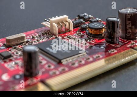Circuit board with condenser and microchips closeup electronic, copper cables, black background Stock Photo