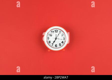 The alarm clock shows 7 am on a red background with a place for copy space. Stock Photo
