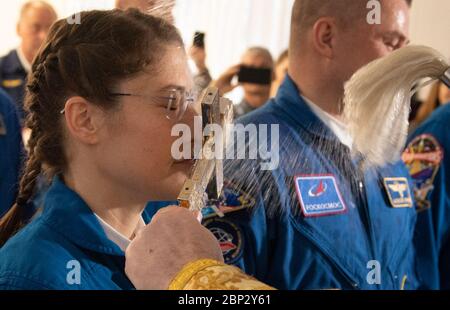 Expedition 59 Crew Blessing  Expedition 59 astronaut Christina Koch of NASA is blessed by a Russian Orthodox Priest in the Cosmonaut Hotel prior to departing for launch on a Soyuz rocket with Nick Hague of NASA, and Alexey Ovchinin of Roscosmos, Thursday, March 14, 2019 in Baikonur, Kazakhstan. Hague, Koch, and Ovchinin will launch March 14, U.S. time, on the Soyuz MS-12 spacecraft from the Baikonur Cosmodrome for a six-and-a-half month mission on the International Space Station. Stock Photo