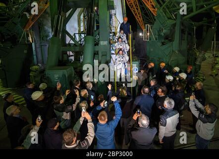 Expedition 55 Preflight  Expedition 55 flight engineer Drew Feustel of NASA, top, flight engineer Ricky Arnold of NASA, middle, and Soyuz Commander Oleg Artemyev of Roscosmos, bottom, wave farewell prior to boarding the Soyuz MS-08 spacecraft for launch, Wednesday, March 21, 2018 at the Baikonur Cosmodrome in Kazakhstan. Feustel, Arnold, and Artemyev will spend the next five months living and working aboard the International Space Station. Stock Photo