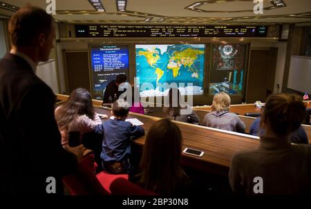 Expedition 55 Soyuz Docking  Friends and family members of the Soyuz MS-08 crew watch a live view of the International Space Station, as seen by cameras onboard the spacecraft with Expedition 55-56 crewmembers Oleg Artemyev of Roscosmos and Ricky Arnold and Drew Feustel of NASA, on screens at the Moscow Mission Control Center as the spacecraft approaches for docking, Friday, March 23, 2018 in Korolev, Russia. The Soyuz MS-08 spacecraft carrying Artemyev, Feustel, and Arnold docked at 3:40 p.m. Eastern time (10:40 p.m. Moscow time) and joined Expedition 55 Commander Anton Shkaplerov of Roscosmo Stock Photo