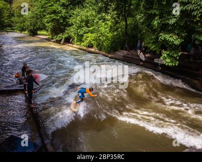 Surfing on a man made wave on urban river Stock Photo