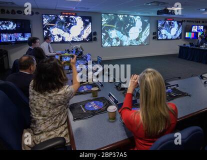 NASA Leadership and Members of Congress watch First All-Woman Spacewalk  Rep. Kendra Horn, D-Okla., right, and Rep. Grace Meng, D-N.Y., are seen as they watch the beginning of the first all-woman spacewalk on Friday, Oct. 18, 2019, from the Space Operations Center at NASA Headquarters in Washington. The first all-woman spacewalk in history began at 7:38am EDT with NASA astronauts Christina Koch and Jessica Meir venturing outside the International Space Station to replace a failed battery charge-discharge unit. This is the fourth spacewalk for Koch and Meir’s first. Stock Photo