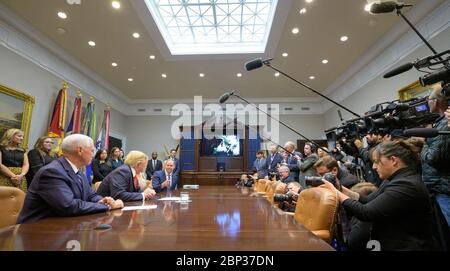 President Trump Calls Astronauts During First All-Woman Spacewalk  President Donald Trump, 2nd from left, joined by Vice President Mike Pence, left, Advisor to the President Ivanka Trump, listens as NASA Administrator Jim Bridenstine talks about the first all-woman spacewalk, Friday, Oct. 18, 2019, from the Roosevelt Room of the White House in Washington. The first all-woman spacewalk in history began at 7:38am EDT with NASA astronauts Christina Koch and Jessica Meir venturing outside the International Space Station to replace a failed battery charge-discharge unit. This is the fourth spacewal Stock Photo