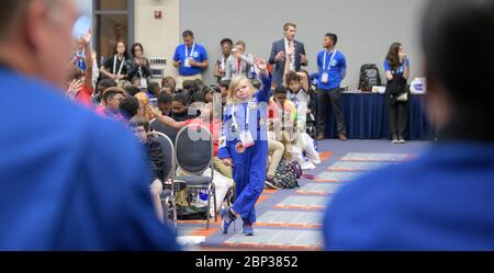 Students participate in a STEM day session at the 70th International Astronautical Congress on October 24, 2019, in Washington, D.C., engaging in discussions on space exploration and technology. Stock Photo