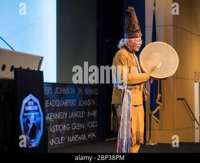 2014 MU69 Naming Ceremony  Reverend Nick Miles, Tecumseh Red Cloud, Pamunkey Tribe, performs a traditional Algonquian chant of “Thank you, O Great Spirit,” at a naming ceremony for 2014 MU69, a celestial body discovered by the New Horizons mission and Hubble Space Telescope, formerly nicknamed “Ultima Thule”, Tuesday, Nov. 12, 2019, at NASA Headquarters in Washington. The new name, “Arrokoth,” means “sky” and is from the Algonquian Languages, spoken by the Powhatan tribes of the region of Maryland it was discovered in. Tribal elders from those tribes approved of the name and participated in th Stock Photo