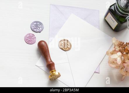 Stamp and envelope on a white table, top view Stock Photo