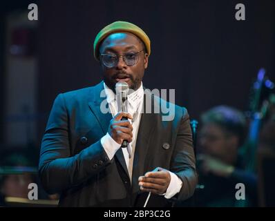 NASA Celebrates 60th Anniversary with National Symphony Orchestra  Will.i.am speaks before conducting the National Symphony Orchestra during the &quot;Space, the Next Frontier&quot; event celebrating NASA's 60th Anniversary, Friday, June 1, 2018 at the John F. Kennedy Center for the Performing Arts in Washington. The event featured music inspired by space including artists Will.i.am, Grace Potter, Coheed &amp; Cambria, John Cho, and guest Nick Sagan, son of Carl Sagan. Stock Photo