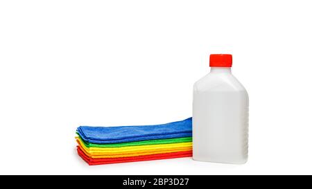 Multi-colored microfiber towels and a bottle of disinfectant isolated over white background. Stock Photo