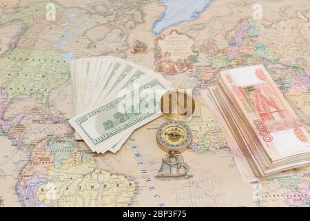 Compass with a bundle of big money are on the map Stock Photo