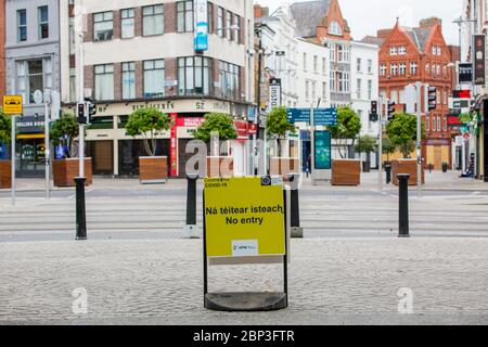 Dublin, Ireland. May 2020. Coronavirus Covid-19 yellow no entry sign on the way out of the St Stephen's Green Park onto the Grafton Street in Dublin. Stock Photo