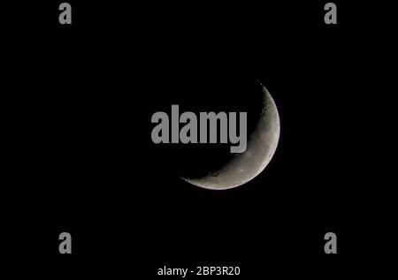 Beautiful photo of the waning moon in close up with dark sky in the background. Stock Photo