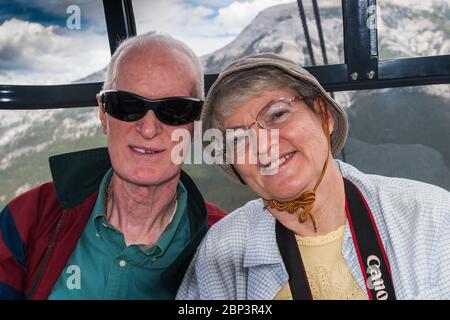 Senior Citizen tourists on Sulphur Mountain Gondola Ride up to the top of Sulphur Mountain in Banff National Park in Alberta, Canada. Stock Photo