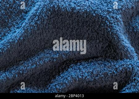 Embossed blue surface of the fabric towel with villi. Fleecy relief texture background Stock Photo