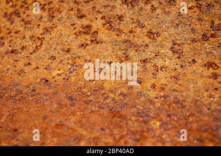 Beautiful grungy rusty picture, taken close up. A third from below is blurred Damaged rust plate. Abstraction, rusty background Stock Photo