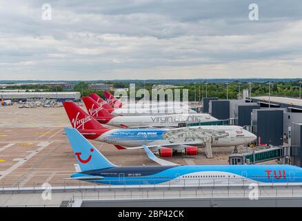 MANCHESTER, UK - MAY 17TH, 2020: Row of now retired Virgin Atlantic Boeing 747 planes parked at the gates at Manchester Airport Stock Photo