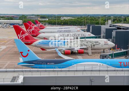 MANCHESTER, UK - MAY 17TH, 2020: Row of now retired Virgin Atlantic Boeing 747 planes parked at the gates at Manchester Airport Stock Photo