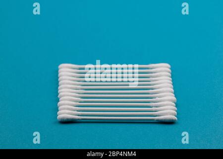 Q-tips, cotton swabs, isolated on bright blue background. Stock Photo