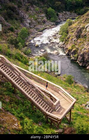 Arouca, Portugal - April 28, 2019: View of the Paiva River, in Portugal, with its rapids and details of the Paiva walkways in the foreground. Stock Photo