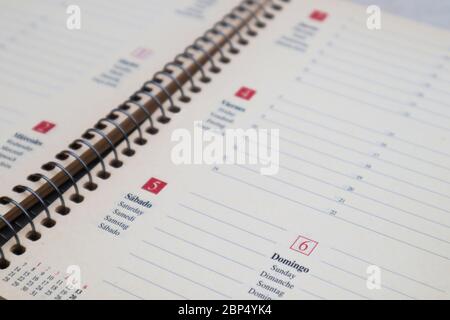 Closeup of any sheet on an empty agenda with texts in different languages Stock Photo