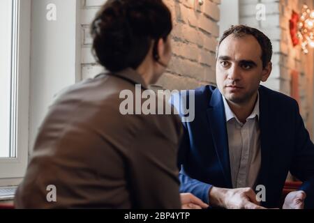 Two people in formal having a meeting in a cafe. Stock Photo